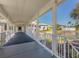 Covered walkway alongside a tranquil pond with manicured landscaping and scenic views under a bright blue sky at 268 Southampton Dr # 309, Venice, FL 34293