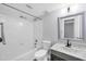 This updated bathroom offers granite counters, undermount sink, and tub with white tile surround at 275 Mission W Trl # G, Venice, FL 34285
