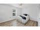 This bedroom features a ceiling fan, wood-look floors and plenty of natural light at 275 Mission W Trl # G, Venice, FL 34285