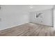 A spacious bedroom featuring wood-look flooring, a ceiling fan, and ample natural light at 275 Mission W Trl # G, Venice, FL 34285