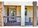 Inviting condo entrance with an open door, a security door, and a small, fenced porch area at 275 Mission W Trl # G, Venice, FL 34285