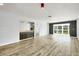 Open-concept living area with updated flooring, cabinetry, and sliding glass doors overlooking a tranquil outdoor setting at 275 Mission W Trl # G, Venice, FL 34285