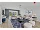 Cozy living room featuring stylish furnishings, modern decor, and a sliding glass door with a picturesque view at 275 Mission W Trl # G, Venice, FL 34285
