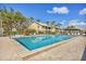 Large community pool with comfortable lounge chairs, palm trees, and a relaxing atmosphere at 275 Mission W Trl # G, Venice, FL 34285