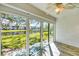 Bright sunroom features large windows, and views of the yard, pond, and beautiful natural light at 275 Mission W Trl # G, Venice, FL 34285