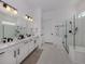 Modern bathroom with glass enclosed shower, double sinks, and neutral decor at 29176 Coral Harbour Dr, Englewood, FL 34223