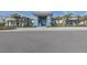 Stunning community clubhouse with vibrant blue accents, well-manicured landscaping, and ample parking at 29176 Coral Harbour Dr, Englewood, FL 34223