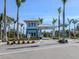A blue-and-white guard house marks the gated entrance to the residential community and features lush landscaping at 29176 Coral Harbour Dr, Englewood, FL 34223