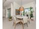 Bright dining area with round table, seating for six, pendant lighting, and access to the pool at 29176 Coral Harbour Dr, Englewood, FL 34223