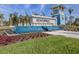 An ornate fountain with the Beachwalk community sign sits within manicured lawns and flowering plants at 29176 Coral Harbour Dr, Englewood, FL 34223
