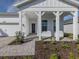 Beautifully landscaped front porch with modern columns and a stylish entrance at 29176 Coral Harbour Dr, Englewood, FL 34223