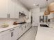 Bright modern kitchen with white cabinets, stainless steel appliances, and a large island at 29176 Coral Harbour Dr, Englewood, FL 34223
