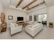Inviting living room with vaulted ceilings, wood beams, and stylish furniture at 29176 Coral Harbour Dr, Englewood, FL 34223