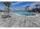 Stunning outdoor pool area with palm trees, lounge chairs, and a large pool perfect for relaxation and recreation at 29176 Coral Harbour Dr, Englewood, FL 34223