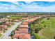 Aerial view of home with screened in pool and golf course view at 297 Martellago Dr, North Venice, FL 34275