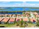Aerial view of home featuring solar panels, pool, and lake view at 297 Martellago Dr, North Venice, FL 34275