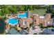 Aerial view showcasing the community amenities including a swimming pool, tennis court, and beautifully landscaped grounds at 297 Martellago Dr, North Venice, FL 34275