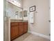 Elegant bathroom with a glass-enclosed shower and vanity with granite countertop at 297 Martellago Dr, North Venice, FL 34275