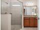 Modern bathroom featuring a glass-enclosed shower, neutral tile, and a granite-topped vanity at 297 Martellago Dr, North Venice, FL 34275