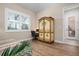 Bright bedroom with a painted armoire, desk and chair, and a large window with shutters at 297 Martellago Dr, North Venice, FL 34275
