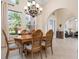 Open floor plan dining room with elegant lighting fixture at 297 Martellago Dr, North Venice, FL 34275