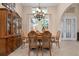 Dining room with wood furniture set and view of the yard at 297 Martellago Dr, North Venice, FL 34275