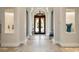 Elegant entryway featuring tile flooring, arched glass door, soaring columns, and architectural details at 297 Martellago Dr, North Venice, FL 34275