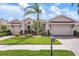 Stunning single-Gathering home with a meticulously maintained lawn, mature landscaping, and a private two-car garage at 297 Martellago Dr, North Venice, FL 34275