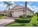 Well-maintained garage with brick driveway, manicured bushes and lawn at 297 Martellago Dr, North Venice, FL 34275