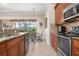 Well-equipped kitchen featuring stainless steel appliances and view into the backyard at 297 Martellago Dr, North Venice, FL 34275