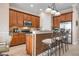Open kitchen with granite counters, stainless appliances, and breakfast bar with seating at 297 Martellago Dr, North Venice, FL 34275