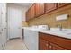 Functional laundry room with washer, dryer, sink, and ample cabinet space at 297 Martellago Dr, North Venice, FL 34275