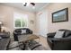 Cozy living room with shuttered windows and neutral decor at 297 Martellago Dr, North Venice, FL 34275