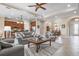 Open-concept living space featuring tile flooring, a ceiling fan, and seamless access to the dining area and kitchen at 297 Martellago Dr, North Venice, FL 34275