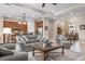 Spacious living room with modern furniture, tile flooring, and a view of the kitchen at 297 Martellago Dr, North Venice, FL 34275