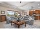 Open-concept living room featuring tile floors, stylish furniture, and a view of the backyard at 297 Martellago Dr, North Venice, FL 34275