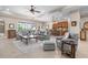 Inviting living room featuring modern furnishings, neutral tones, and an open layout seamlessly connecting to the kitchen at 297 Martellago Dr, North Venice, FL 34275