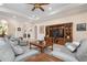 Spacious living room with tile floors, ceiling fan, comfortable seating, and a view into other rooms at 297 Martellago Dr, North Venice, FL 34275