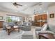 Bright living room with modern furniture, tile flooring, and an open layout with a view to the kitchen at 297 Martellago Dr, North Venice, FL 34275