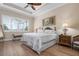 Comfortable main bedroom featuring tray ceiling and ample natural light at 297 Martellago Dr, North Venice, FL 34275