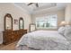Well-lit bedroom with large window and dresser at 297 Martellago Dr, North Venice, FL 34275