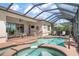 Covered patio with pool and spa combo, with views of the backyard at 297 Martellago Dr, North Venice, FL 34275