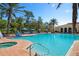 Resort-style pool area with lounge chairs, umbrellas, and a lush tropical setting for relaxation and enjoyment at 297 Martellago Dr, North Venice, FL 34275