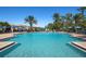 Large outdoor pool with lounge chairs, providing a serene and inviting space for relaxation and recreation at 297 Martellago Dr, North Venice, FL 34275