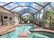 Beautiful pool and spa in screened patio with lush landscaping at 297 Martellago Dr, North Venice, FL 34275