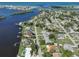 Aerial photo of the property shows it's location along the water and in the neighborhood, surrounded by mature trees at 302 Bayview Pkwy, Nokomis, FL 34275