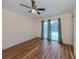 The bedroom features a ceiling fan and sliding glass doors that offer a nice view and natural light at 302 Bayview Pkwy, Nokomis, FL 34275