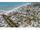 Breathtaking aerial view showcasing a coastal community with homes, canals, and direct beach access to the Gulf of Mexico at 388 Flamingo Dr, Venice, FL 34285