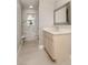 Elegant bathroom featuring a marble-tiled shower and a stylish vanity with granite countertop at 388 Flamingo Dr, Venice, FL 34285