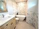 Modern bathroom featuring marble walls, a soaking tub, and a sleek vanity at 388 Flamingo Dr, Venice, FL 34285